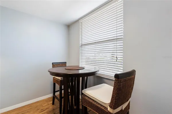 a kitchen with a sink and a wooden floor