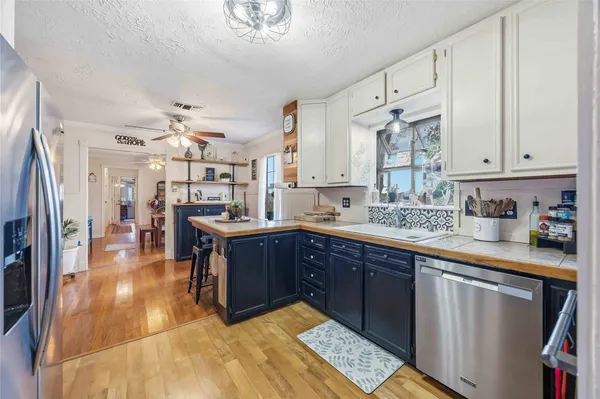 a kitchen with stainless steel appliances granite countertop a sink and a stove