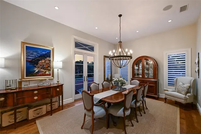 a living room with furniture kitchen view and a chandelier