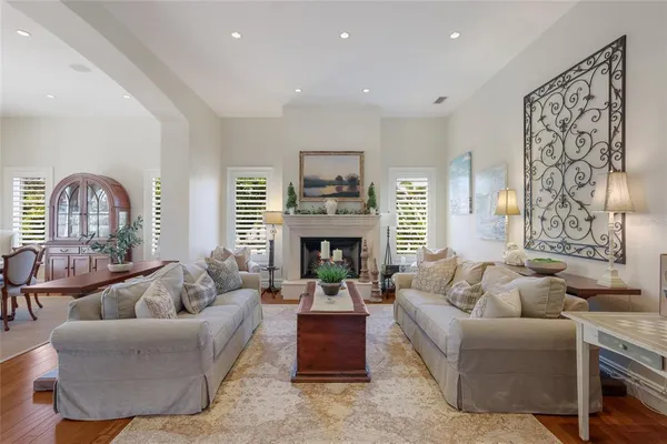 a living room with furniture kitchen view and a chandelier