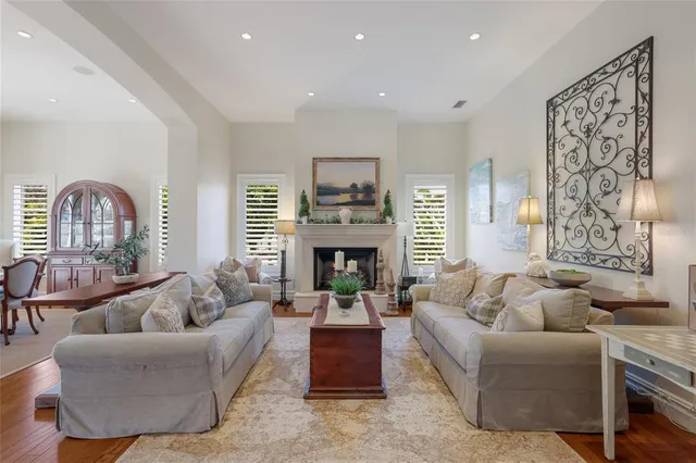 a dining room with granite countertop a table chairs and wooden floor