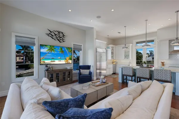 a living room with furniture and a chandelier