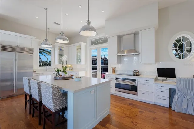 a spacious bedroom with a bed and a flat tv screen on dresser