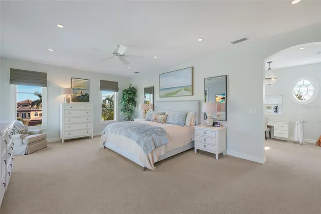a balcony with chairs and a potted plant