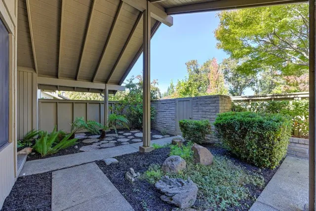 a view of house with river and trees in the background