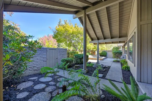 a view of a house with porch and garden