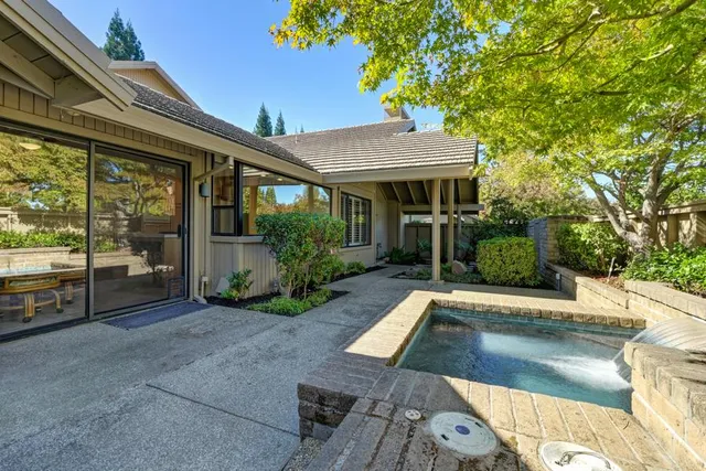 a living room with furniture fireplace and a large window
