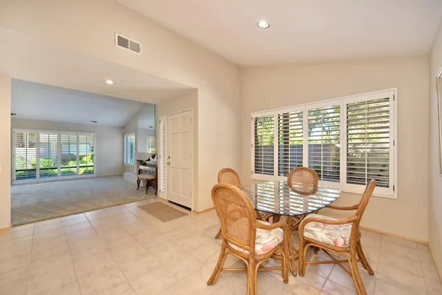 a dining room with furniture and window