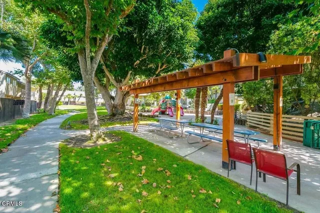 a view of a park with sitting area and garden