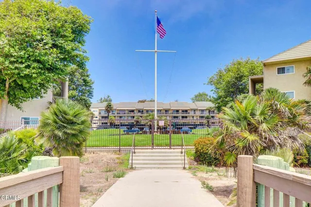 a view of a street with a house in the background