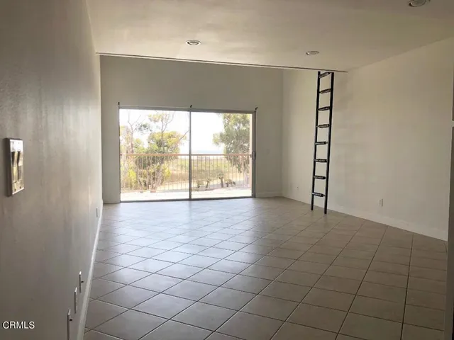 an empty room with windows and entrance