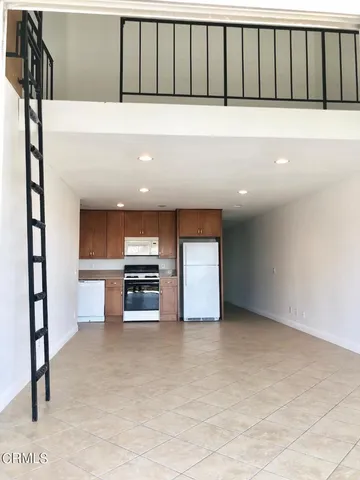 a view of kitchen and refrigerator