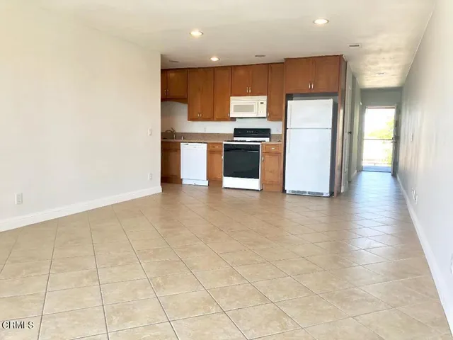 a kitchen with stainless steel appliances a refrigerator and a stove top oven