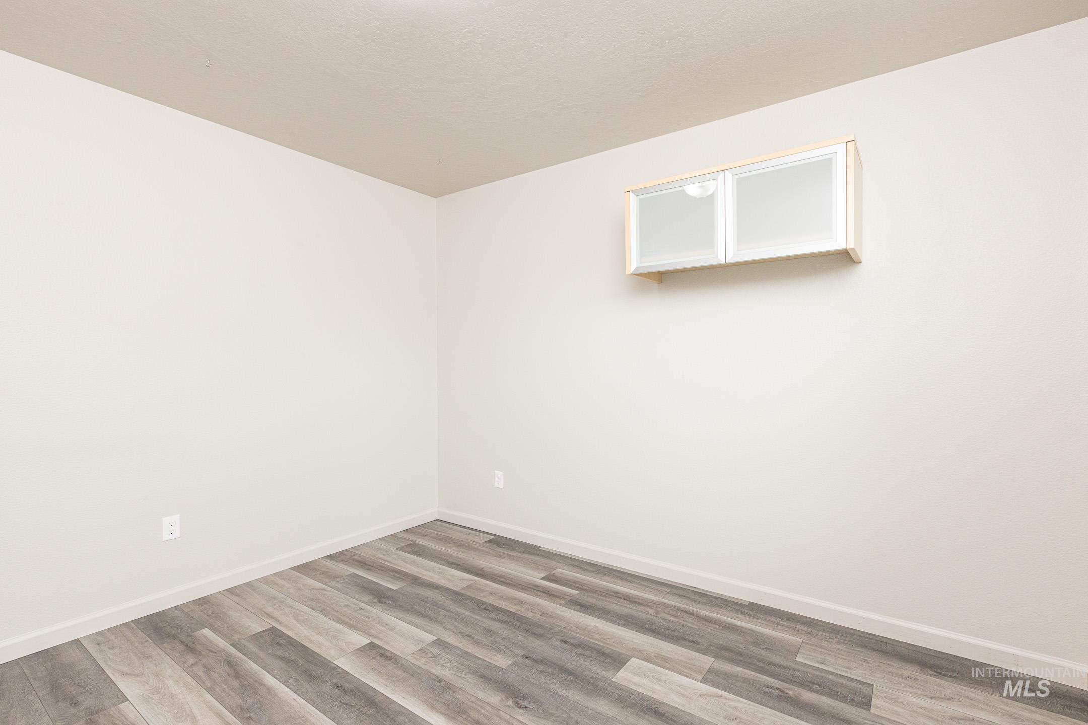 643 North Manship Avenue Meridian, ID 83642 - Photo 12 of 32 Spare room featuring wood finished floors and baseboards