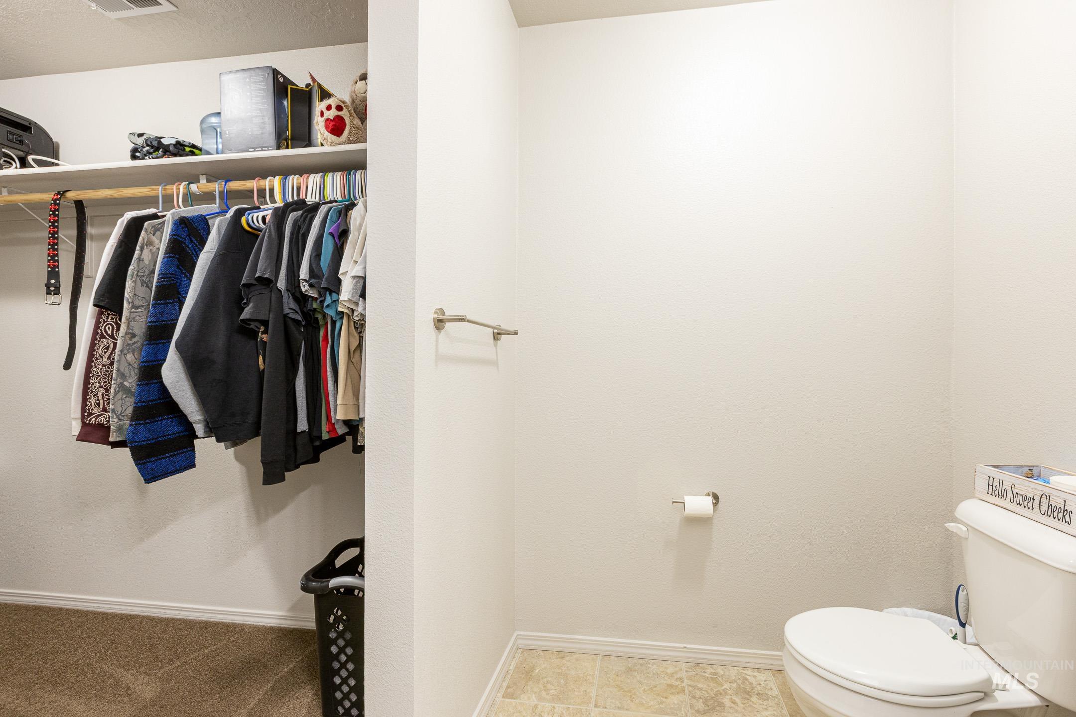 643 North Manship Avenue Meridian, ID 83642 - Photo 18 of 32 Bathroom featuring baseboards and a walk in closet