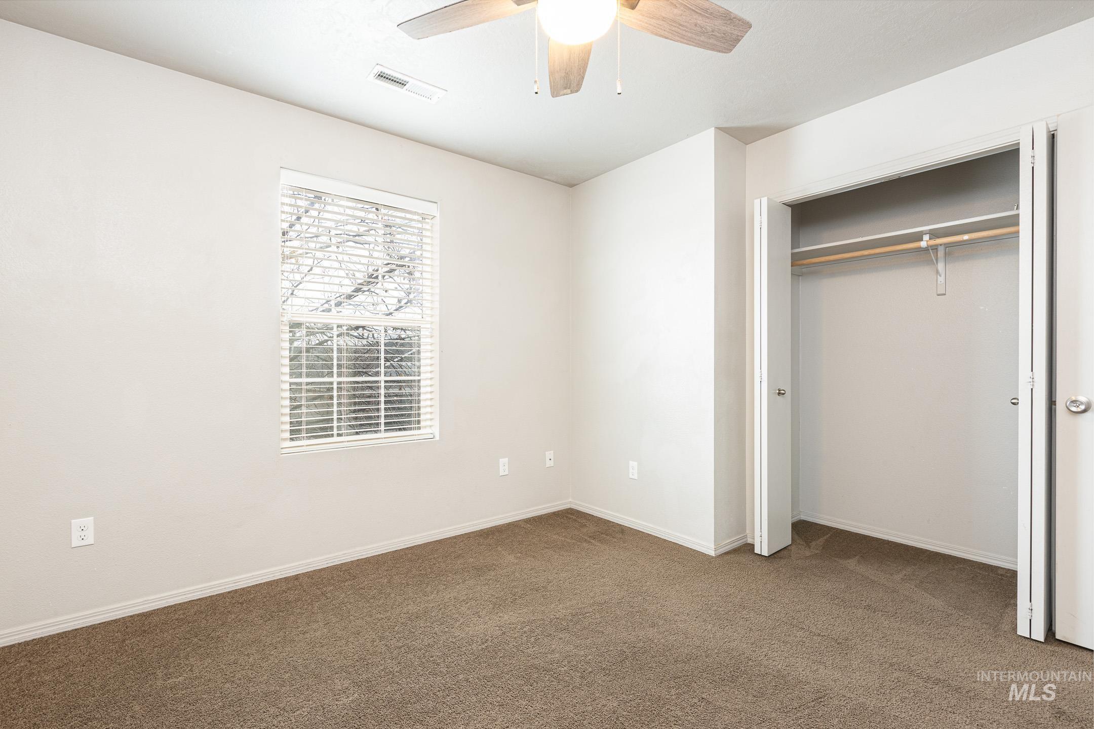 643 North Manship Avenue Meridian, ID 83642 - Photo 24 of 32 Unfurnished bedroom with carpet flooring, a closet, and ceiling fan