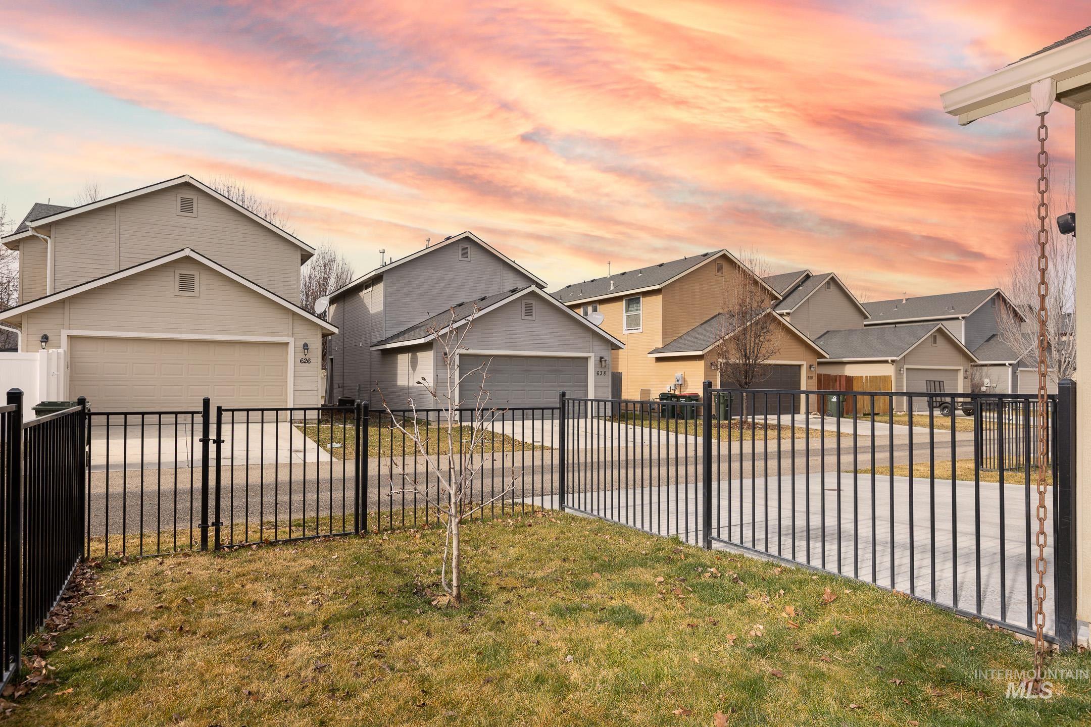 643 North Manship Avenue Meridian, ID 83642 - Photo 27 of 32 View of front facade with a residential view, concrete driveway, and a garage