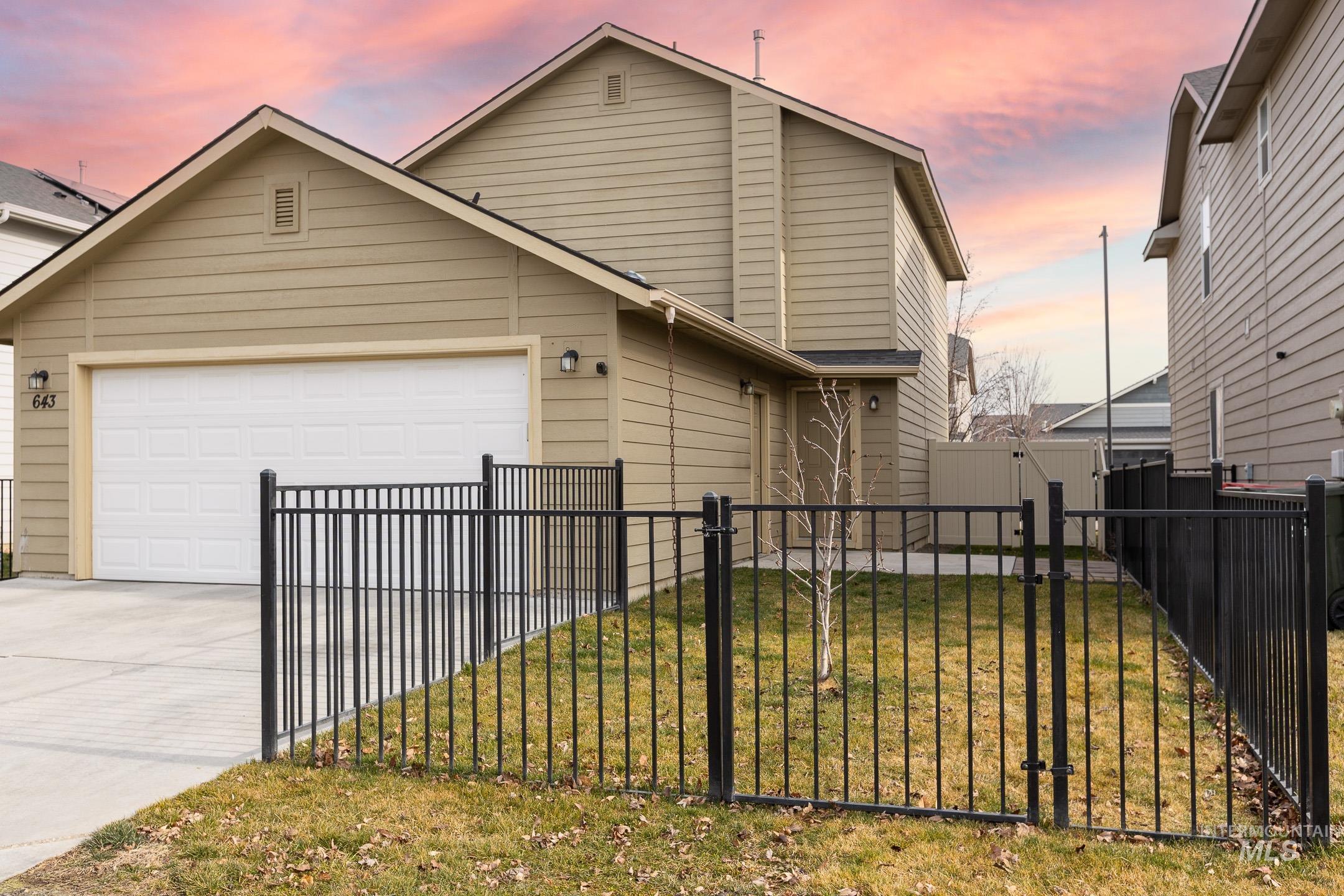643 North Manship Avenue Meridian, ID 83642 - Photo 29 of 32 View of front of property featuring a gate, driveway, and a garage