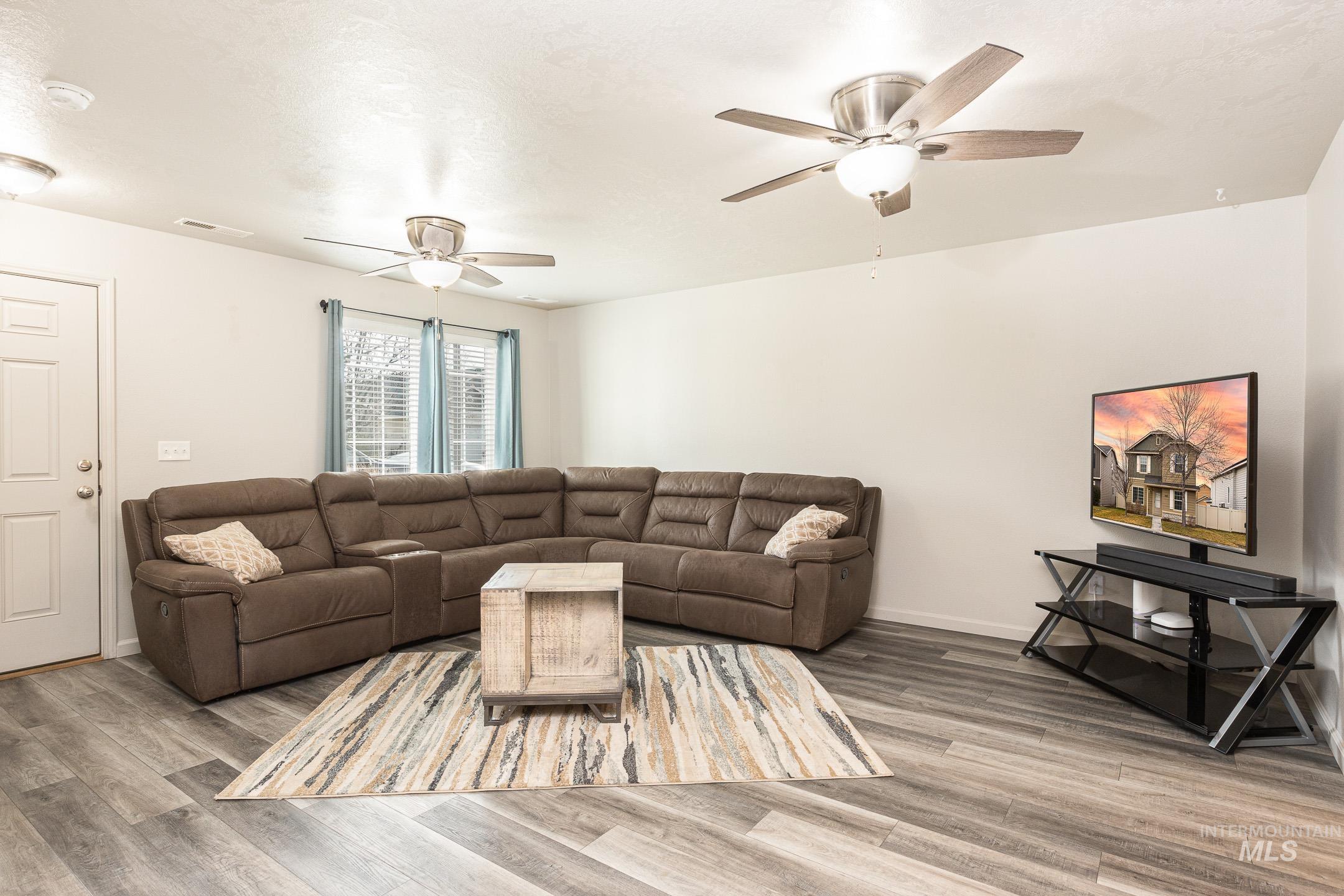643 North Manship Avenue Meridian, ID 83642 - Photo 3 of 32 Living area with light wood-style flooring and ceiling fan
