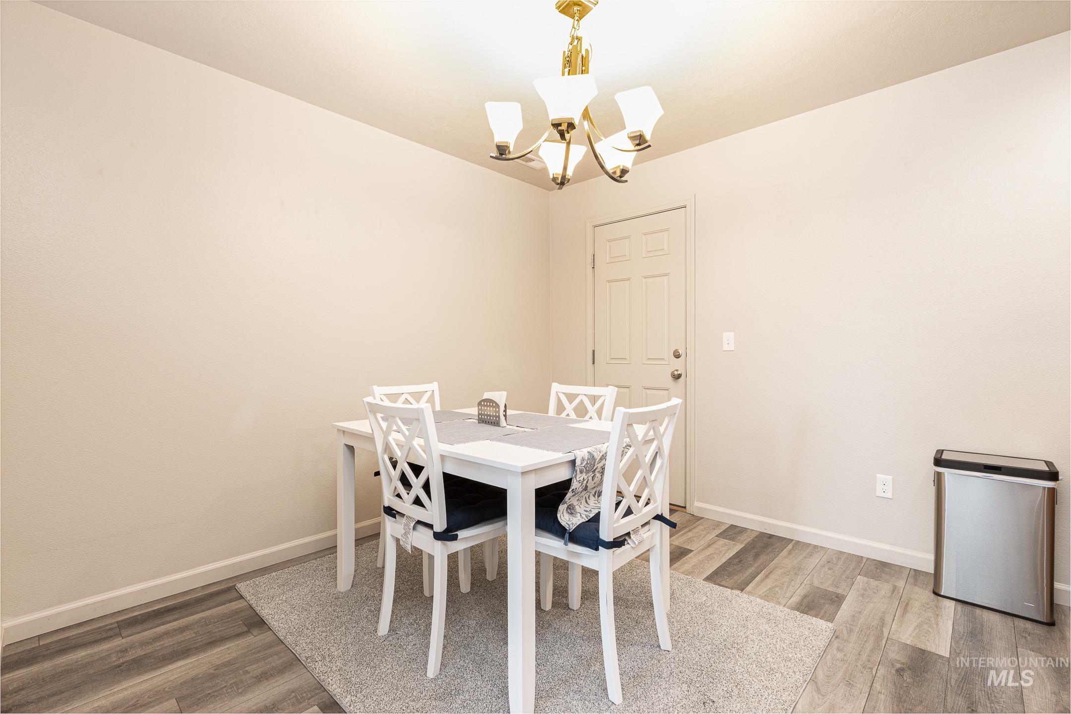 643 North Manship Avenue Meridian, ID 83642 - Photo 6 of 32 Dining space featuring light wood-style floors and suspended lighting