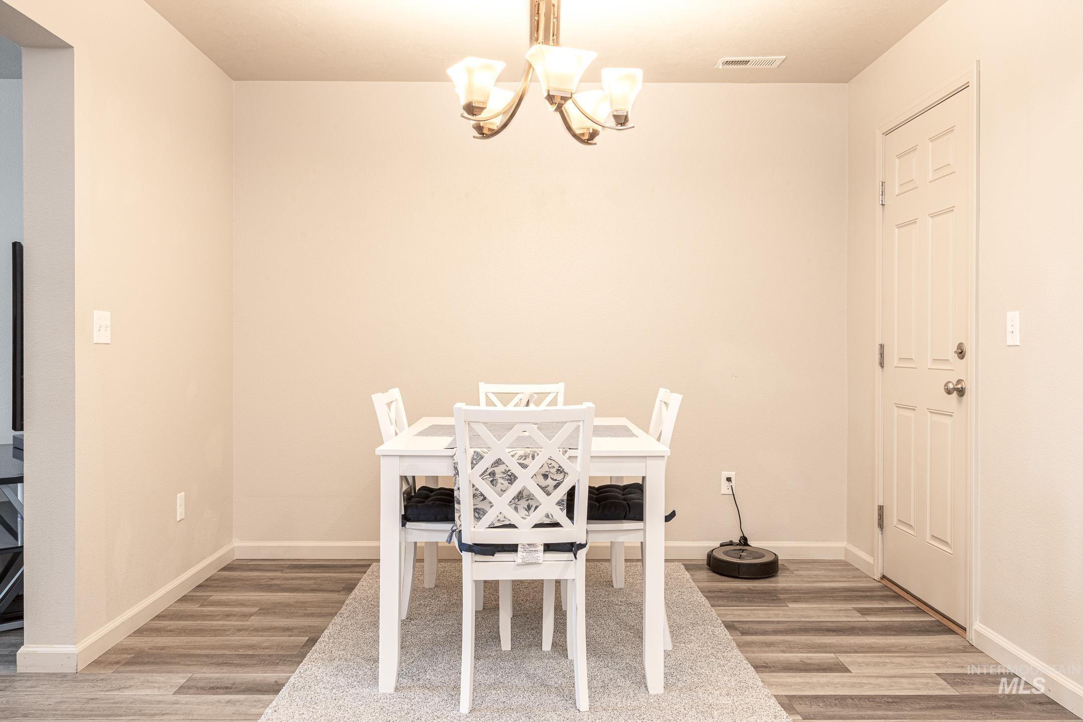643 North Manship Avenue Meridian, ID 83642 - Photo 7 of 32 Dining space featuring light wood-style floors and suspended lighting