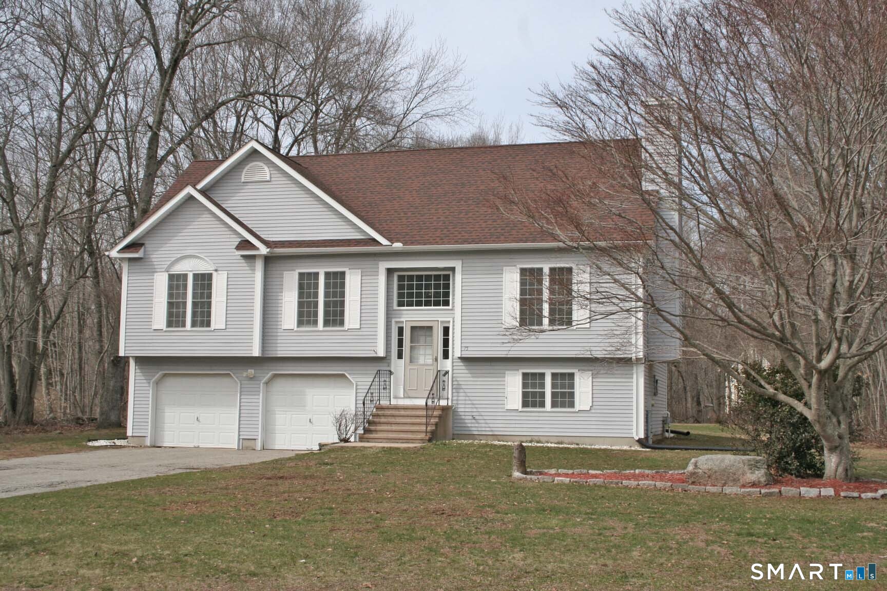 75 Brindlewood Path Colchester, CT 06415 - Photo 1 of 1 a front view of a house with a yard and garage