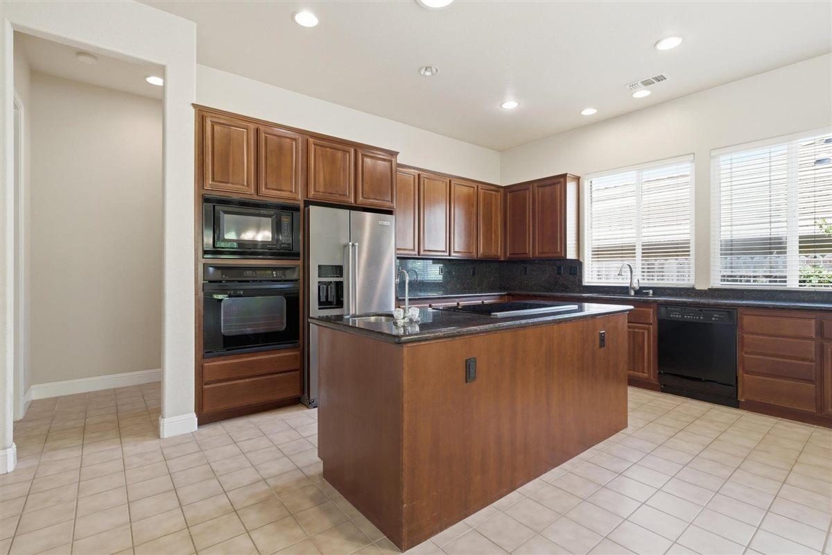4129 Poppleton Way Carmichael, CA 95608 - Photo 13 of 48 a kitchen with stainless steel appliances granite countertop a refrigerator and a sink