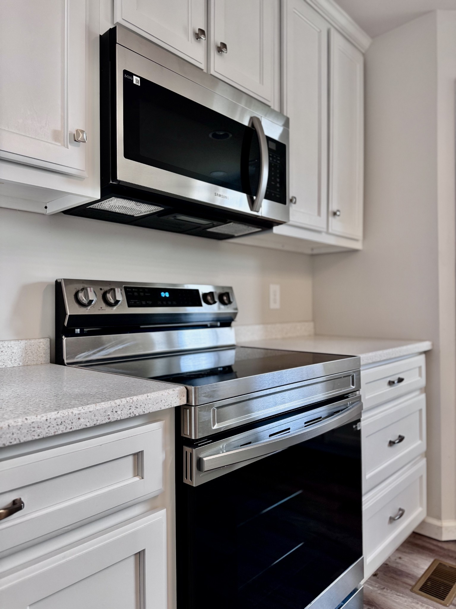 1122 Brannon Road Lawrenceburg, TN 38464 - Photo 7 of 21 a kitchen with stainless steel appliances granite countertop white cabinets and a stove top oven