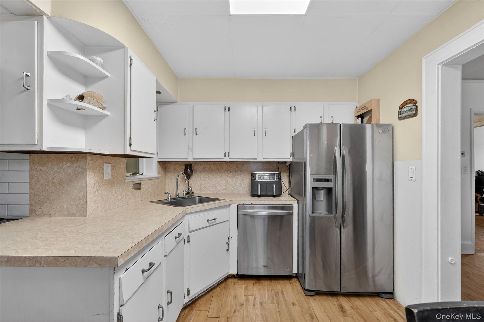 560 Locust Avenue Port Chester, NY 10573 - Photo 15 of 35 a kitchen with a sink a refrigerator and cabinets