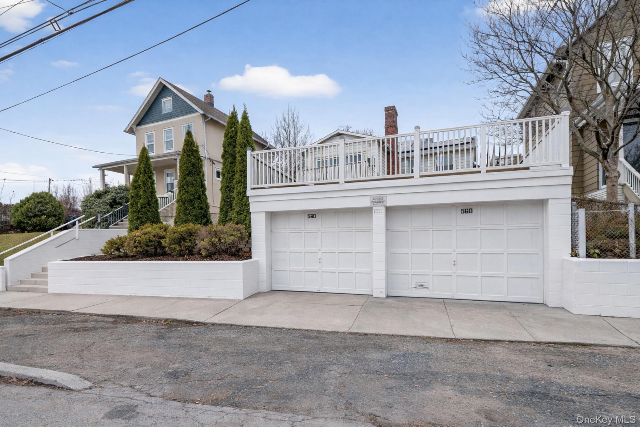 560 Locust Avenue Port Chester, NY 10573 - Photo 2 of 35 a front view of a house with a yard and garage