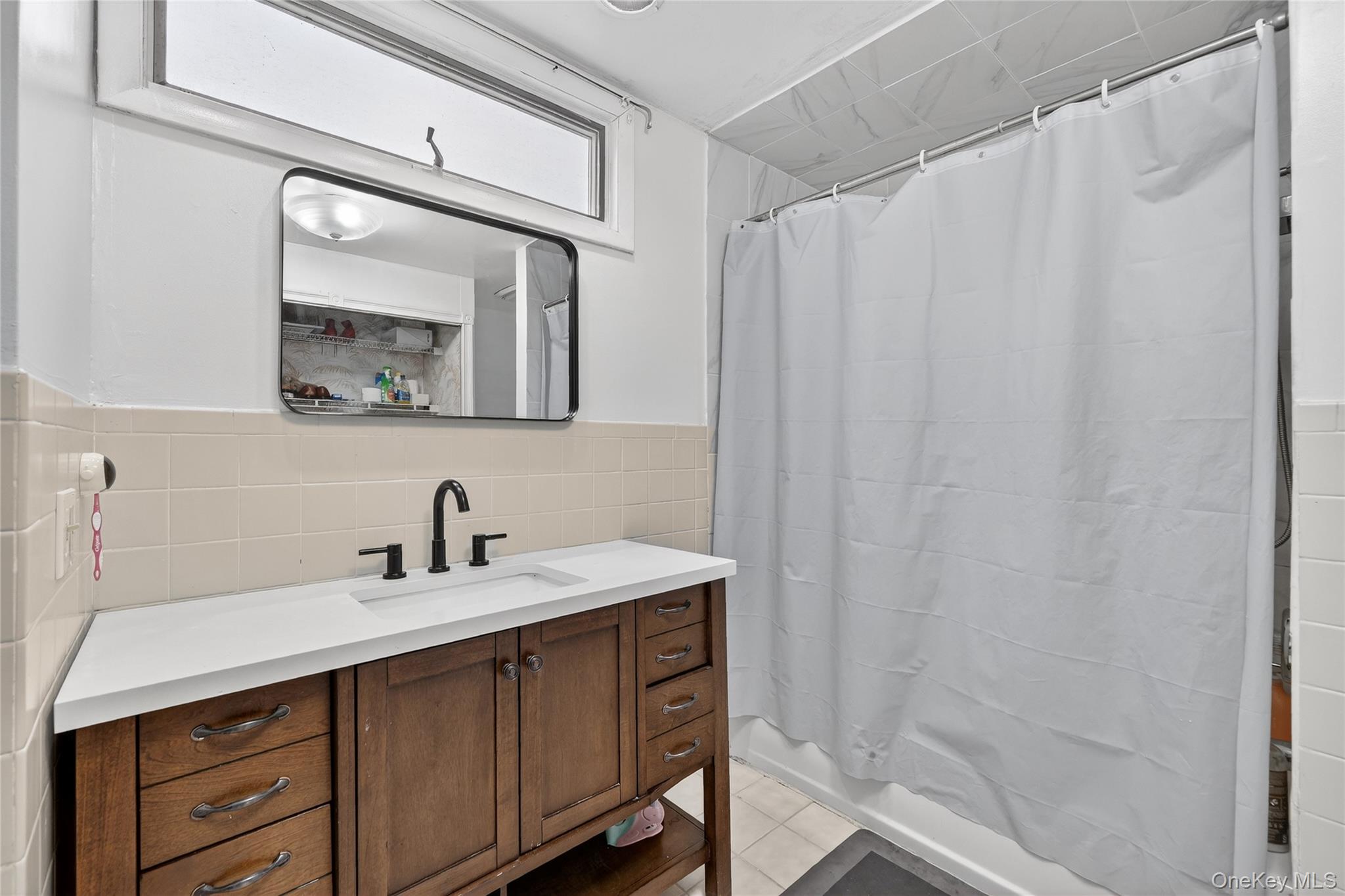 560 Locust Avenue Port Chester, NY 10573 - Photo 21 of 35 a bathroom with a sink and a mirror