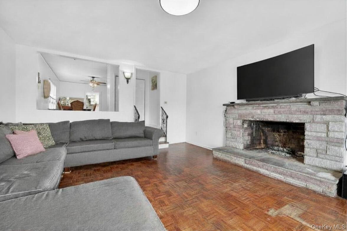 560 Locust Avenue Port Chester, NY 10573 - Photo 9 of 35 a living room with furniture a flat screen tv and a fireplace