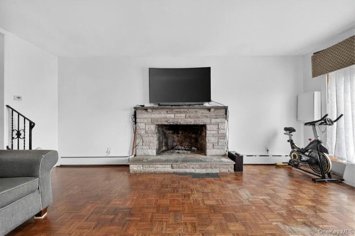 560 Locust Avenue Port Chester, NY 10573 - Photo 10 of 35 a living room with furniture a flat screen tv and a fireplace