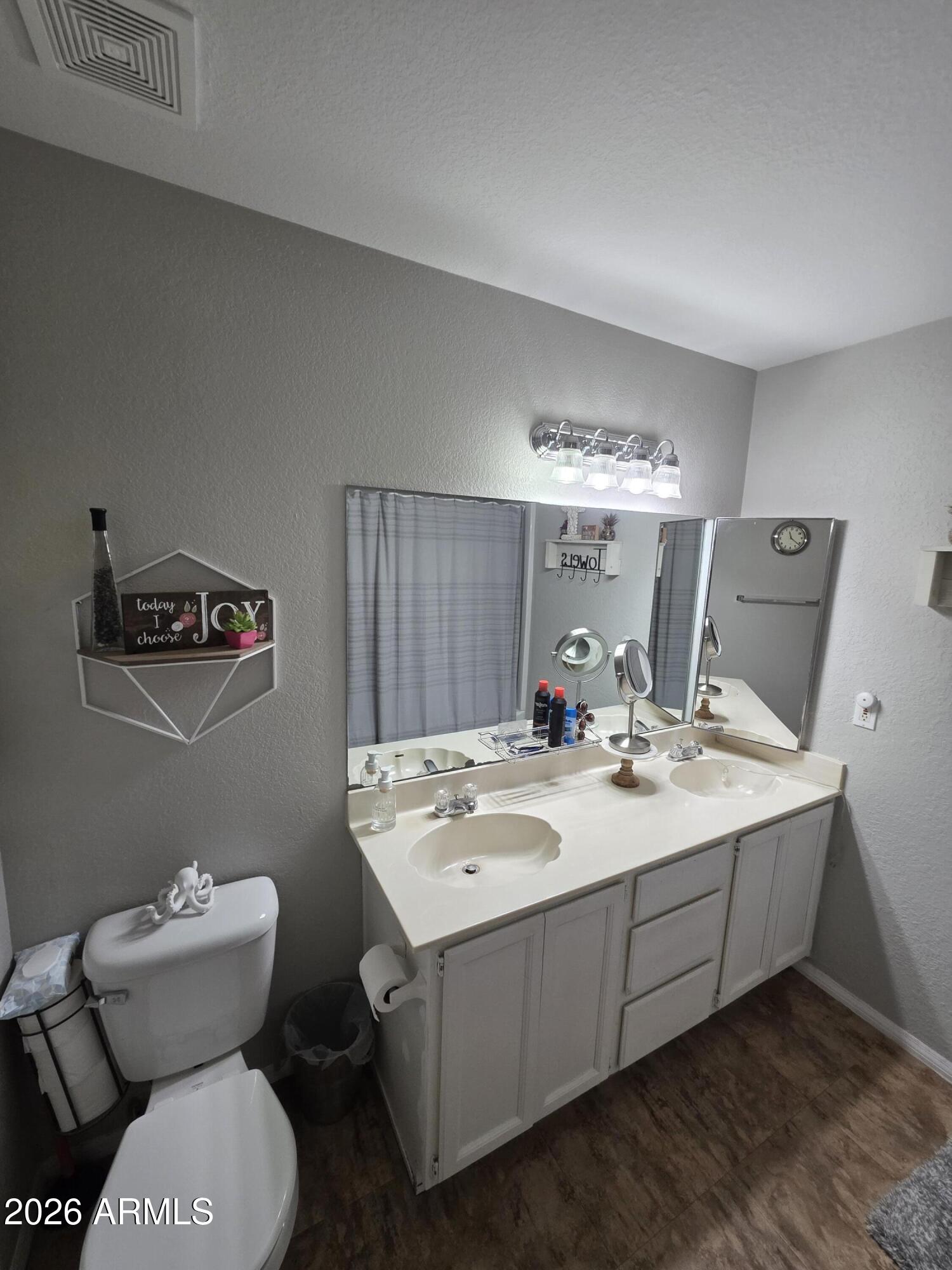 222 West Brown Road, Unit 107 Mesa, AZ 85201 - Photo 14 of 24 a bathroom with a toilet sink and mirror