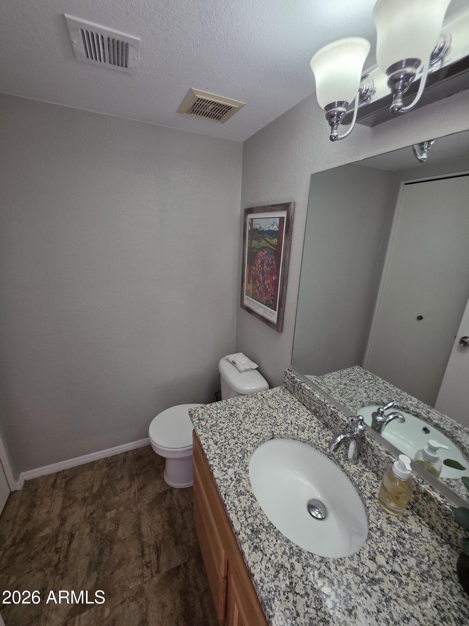 222 West Brown Road, Unit 107 Mesa, AZ 85201 - Photo 15 of 24 a bathroom with a granite countertop sink and a mirror