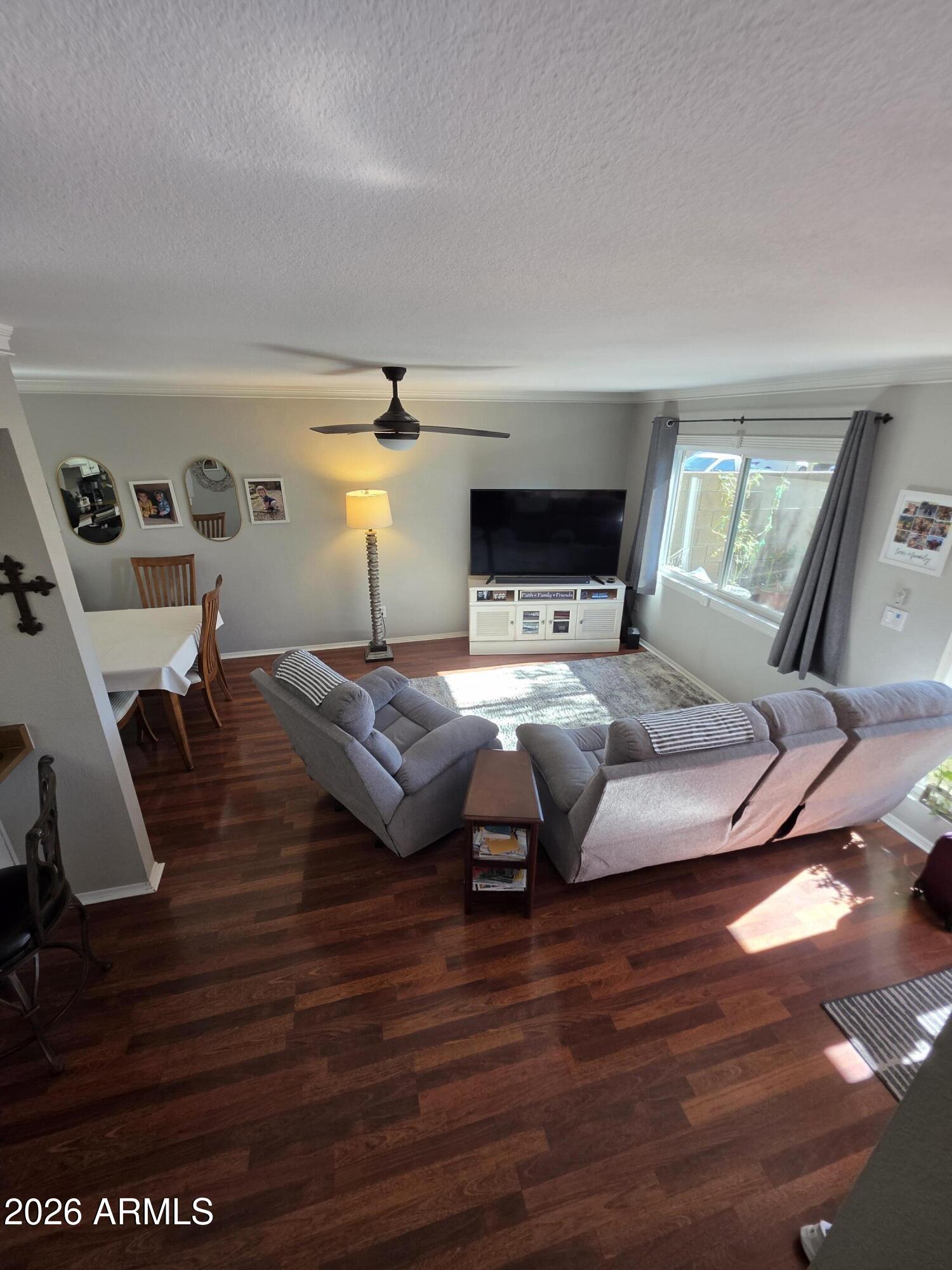 222 West Brown Road, Unit 107 Mesa, AZ 85201 - Photo 5 of 24 a living room with furniture and wooden floor