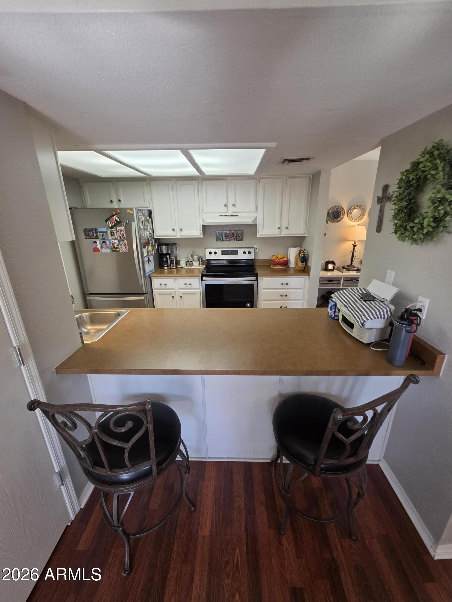 222 West Brown Road, Unit 107 Mesa, AZ 85201 - Photo 6 of 24 a kitchen with a table and chairs