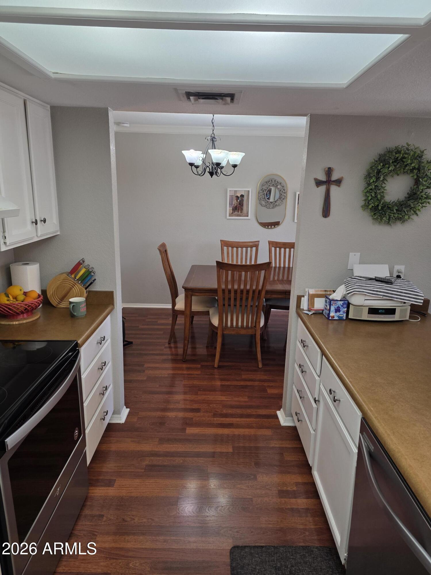 222 West Brown Road, Unit 107 Mesa, AZ 85201 - Photo 8 of 24 a kitchen with stainless steel appliances granite countertop a stove a sink dishwasher and a refrigerator with wooden floor