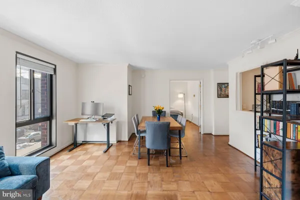 a bedroom with furniture and large windows