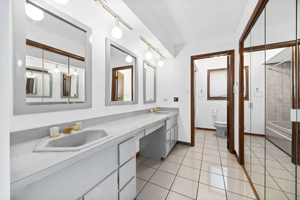 a bathroom with a sink a mirror and a shower