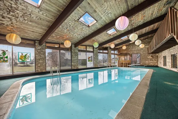 a view of a swimming pool with seating space