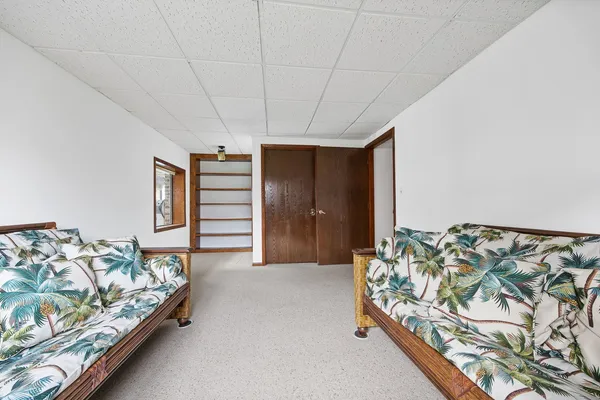 a bed sitting in a bedroom next to a window