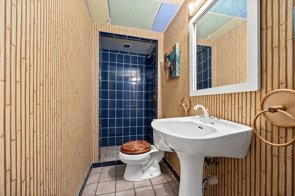 a bathroom with a sink a toilet and mirror