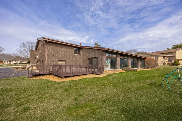 a view of a house with a yard and porch