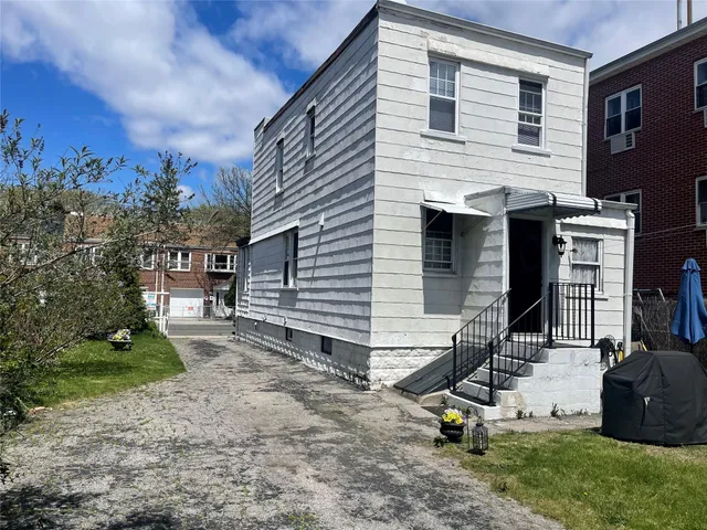 a view of a backyard with a chair and a table
