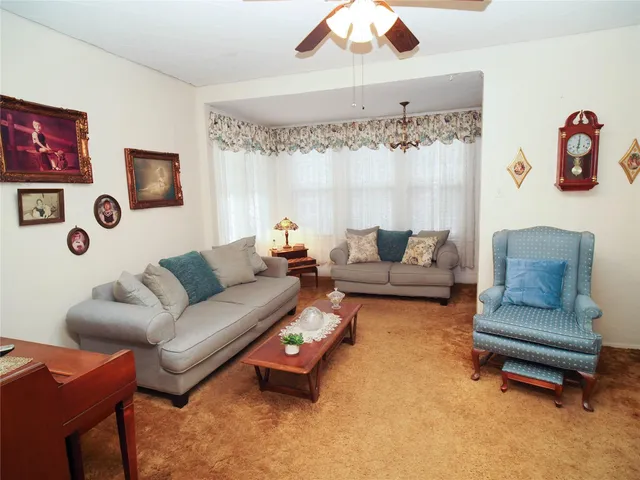 a living room with furniture and a white bed