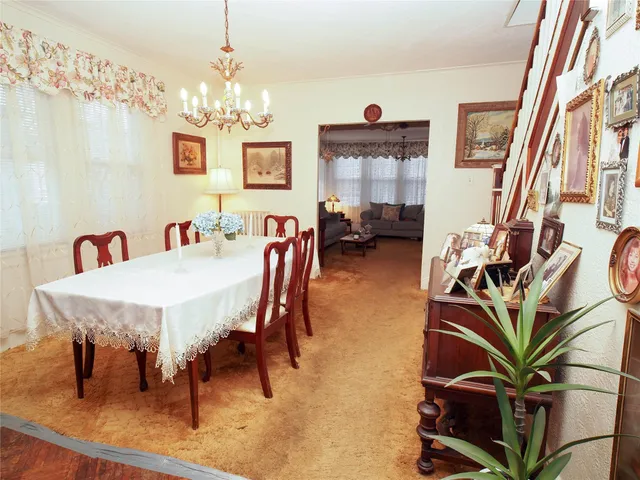 a view of a dining room with furniture and chandelier