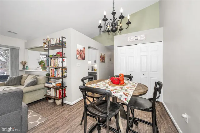 a view of a dining room with furniture and chandelier
