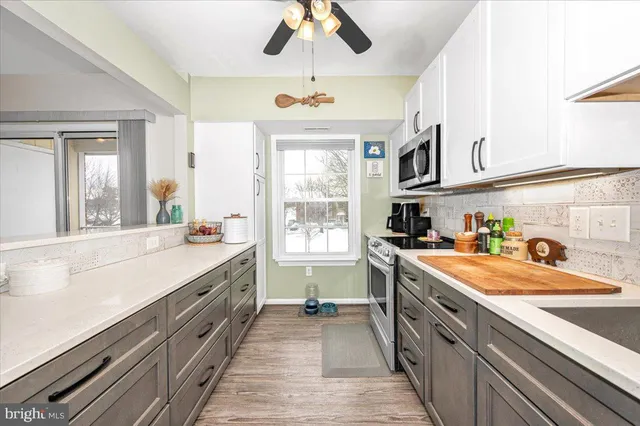 a open kitchen with stainless steel appliances granite countertop a sink stove and cabinets