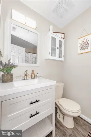 a bathroom with a toilet a sink and a mirror